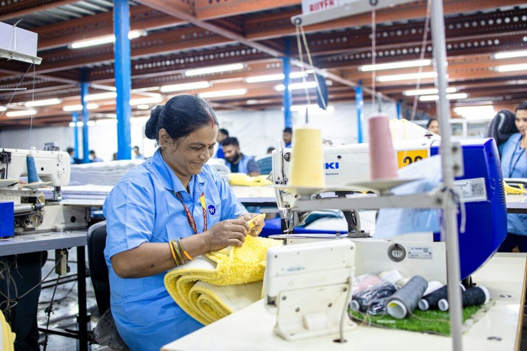 Woman sewing garments in a textile factory.